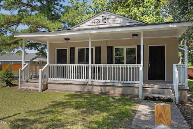 view of front of home with covered porch and a front yard