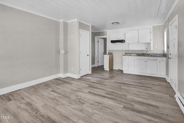 kitchen featuring light wood-type flooring, white cabinetry, and ornamental molding