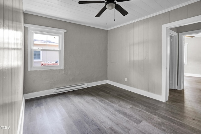 unfurnished room featuring ceiling fan, dark hardwood / wood-style flooring, ornamental molding, and a baseboard heating unit