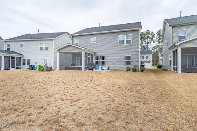 back of property with a sunroom