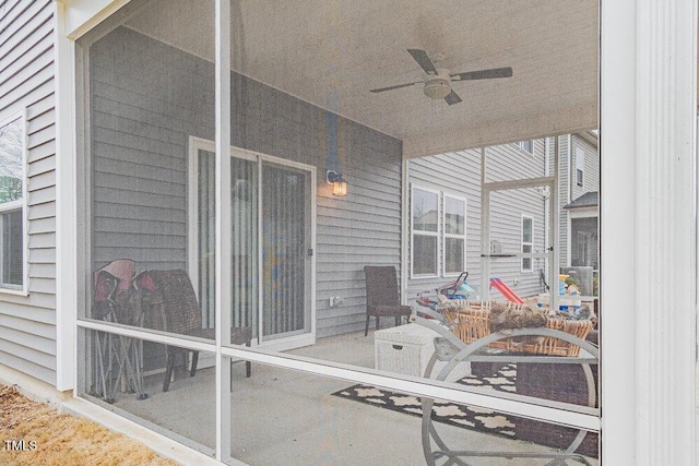 sunroom featuring ceiling fan