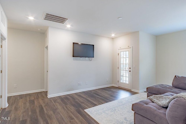 living room with dark hardwood / wood-style flooring