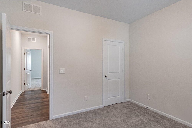 spare room featuring wood-type flooring