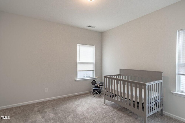 bedroom with carpet flooring and a nursery area