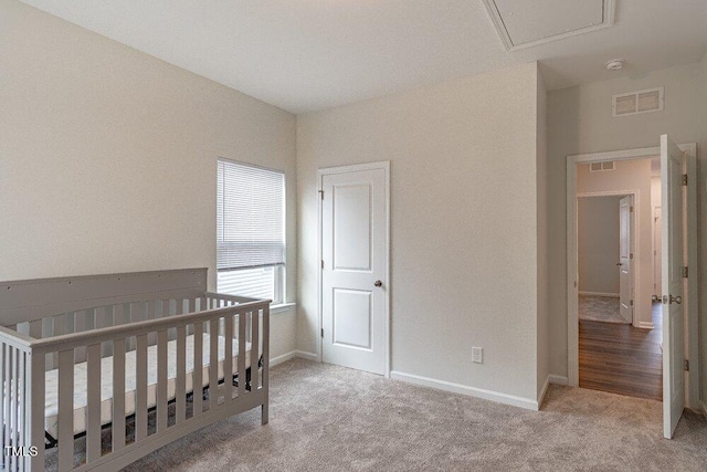 carpeted bedroom with a nursery area