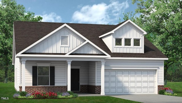 view of front of house featuring a garage and a front lawn