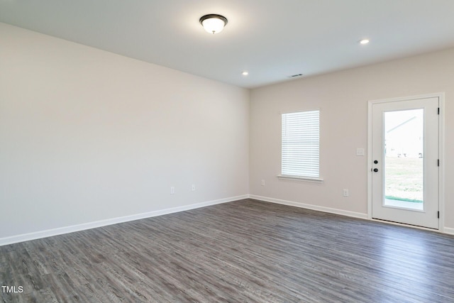 unfurnished room featuring dark hardwood / wood-style flooring