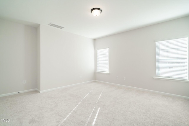 spare room with light colored carpet