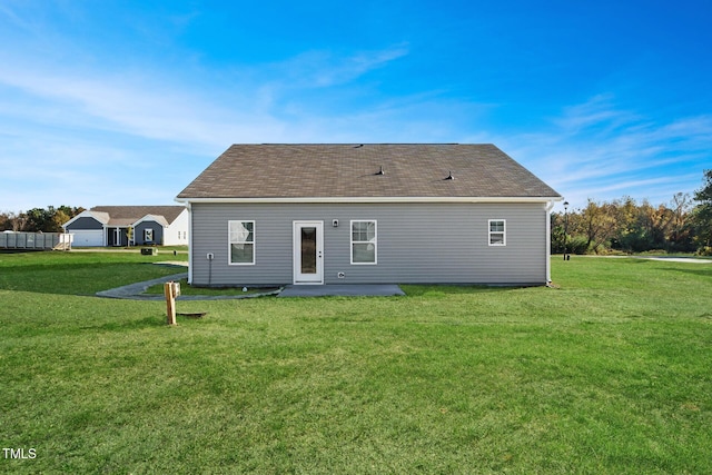 back of house with a lawn and a patio area