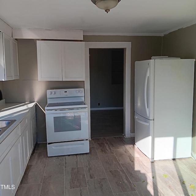 kitchen featuring white cabinets, white appliances, and sink