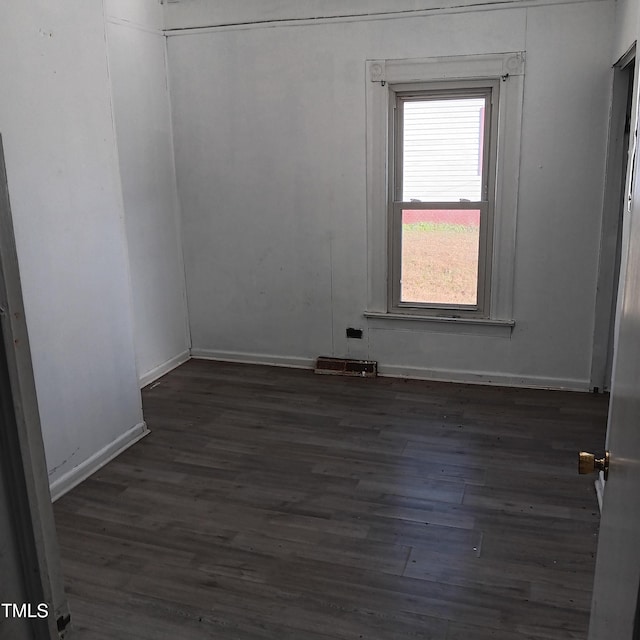 unfurnished room with dark hardwood / wood-style floors