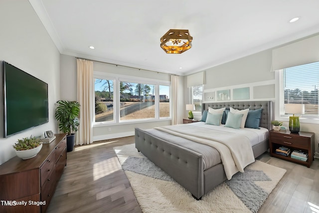 bedroom with hardwood / wood-style floors and ornamental molding