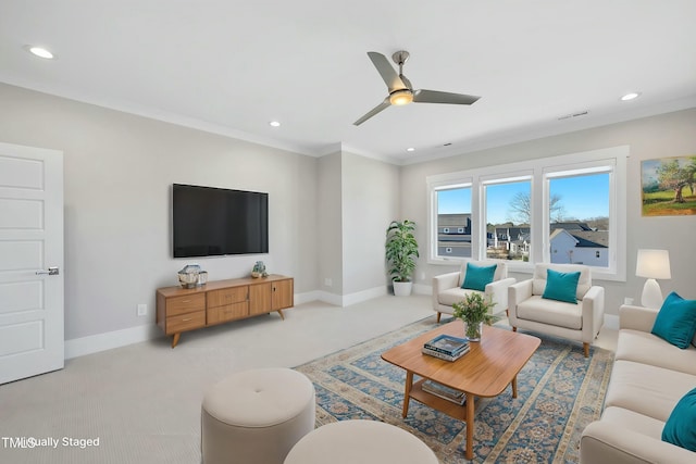 carpeted living room featuring ceiling fan and ornamental molding