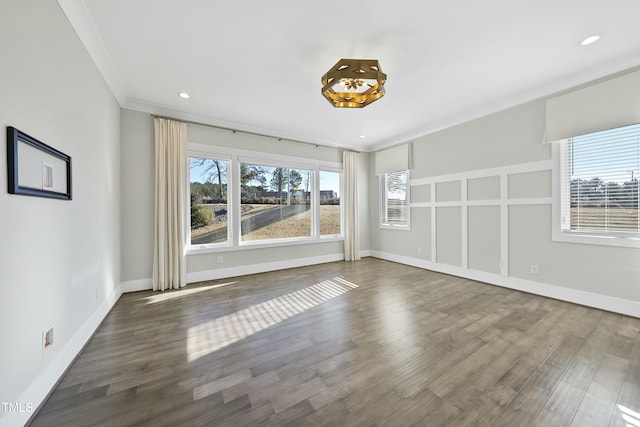 unfurnished room with hardwood / wood-style flooring and ornamental molding