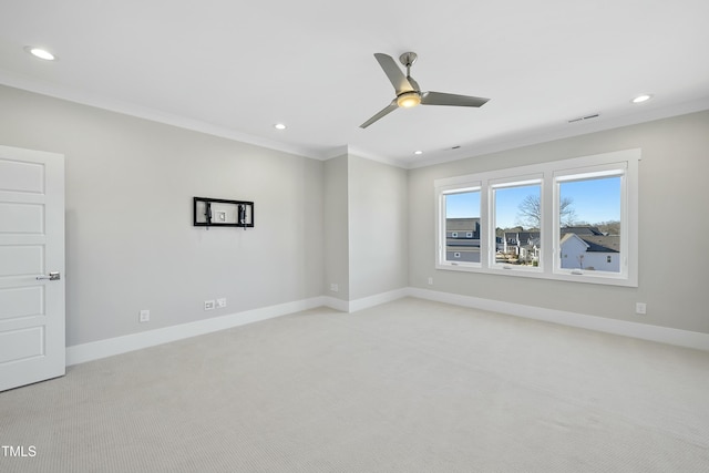 unfurnished room with crown molding, ceiling fan, and light colored carpet