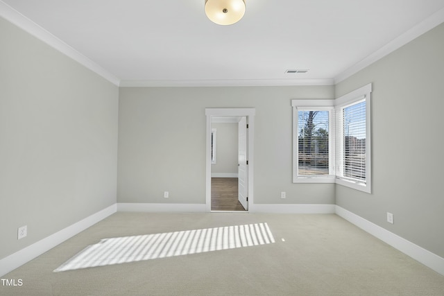 unfurnished room with crown molding and light carpet