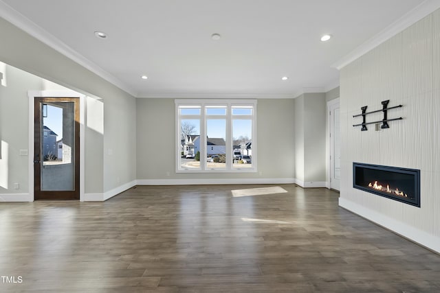 unfurnished living room featuring a large fireplace, dark hardwood / wood-style flooring, and crown molding