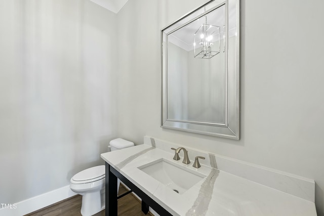 bathroom featuring sink, hardwood / wood-style floors, and toilet