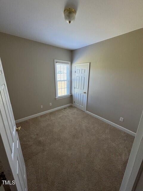 unfurnished bedroom featuring dark colored carpet