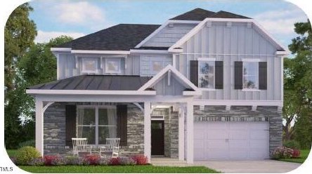 view of front facade featuring a porch and a garage