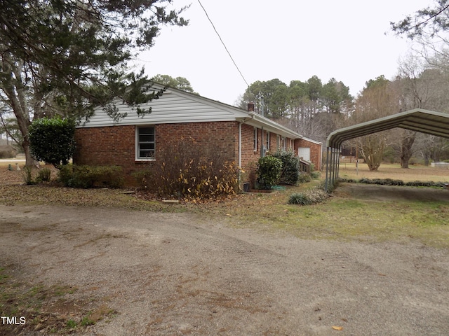 view of side of property with a carport