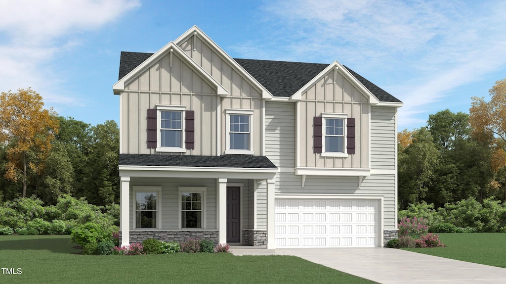 view of front of home featuring a garage and a front lawn