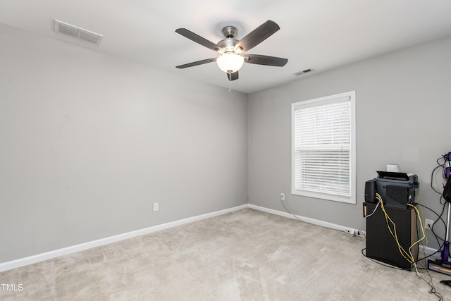 interior space featuring ceiling fan and light carpet