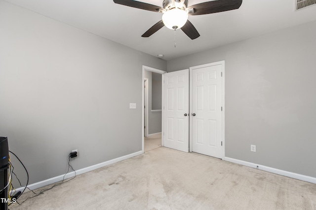 unfurnished bedroom featuring ceiling fan and light carpet
