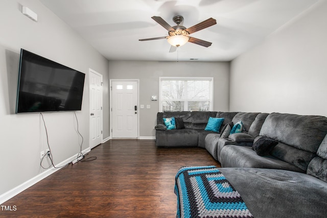 living room with ceiling fan and dark wood-type flooring