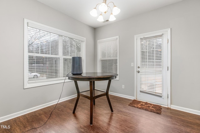 office space featuring a chandelier and wood-type flooring