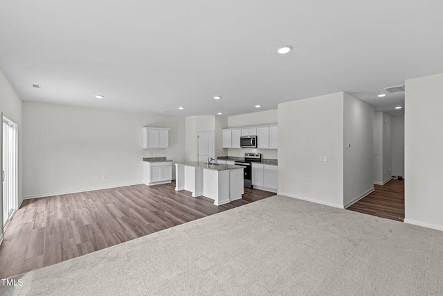 unfurnished living room with dark wood-type flooring and sink