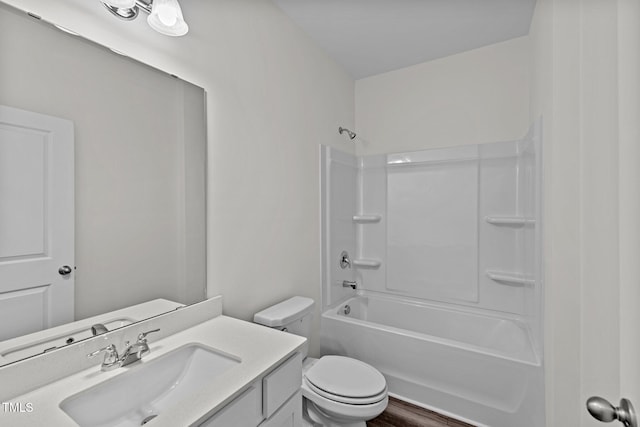 full bathroom featuring toilet, vanity, tub / shower combination, and hardwood / wood-style flooring