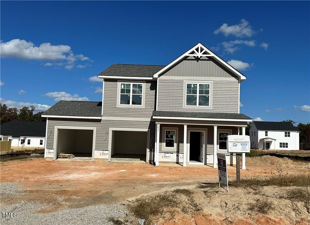 view of front of house featuring covered porch and a garage