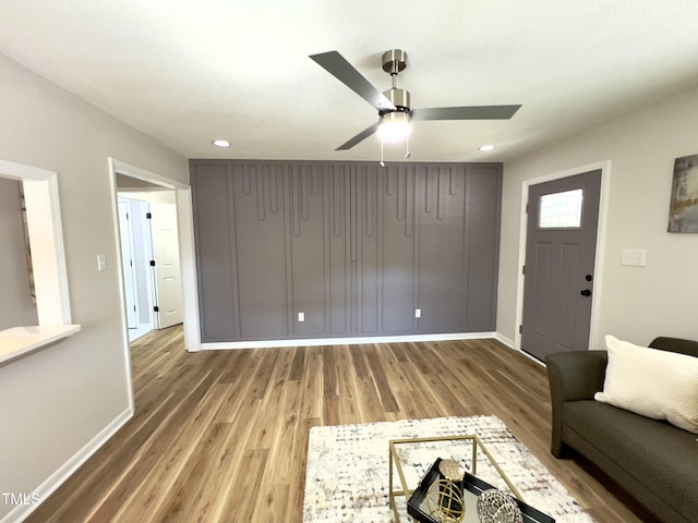 unfurnished living room with hardwood / wood-style floors and ceiling fan