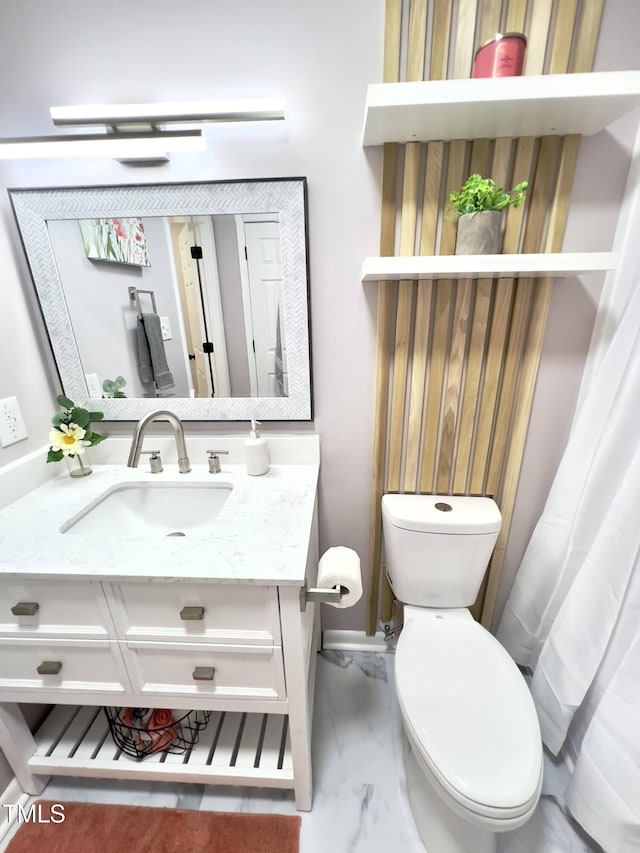 bathroom featuring vanity and toilet