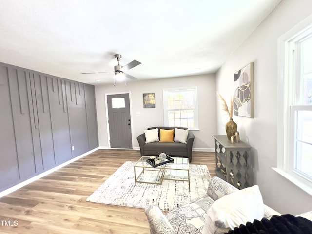 living room featuring hardwood / wood-style floors and ceiling fan