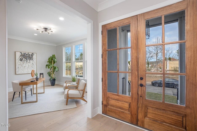 entryway featuring light wood-type flooring, french doors, and ornamental molding