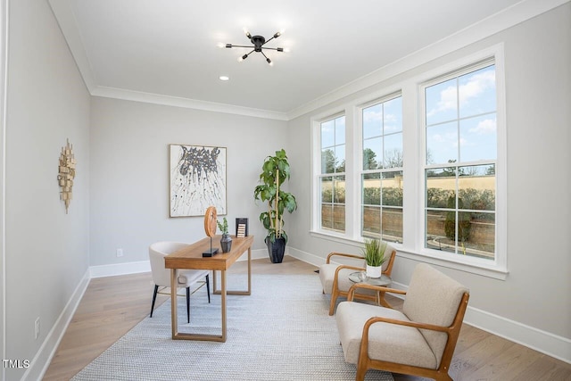 home office with a notable chandelier, ornamental molding, and light hardwood / wood-style floors