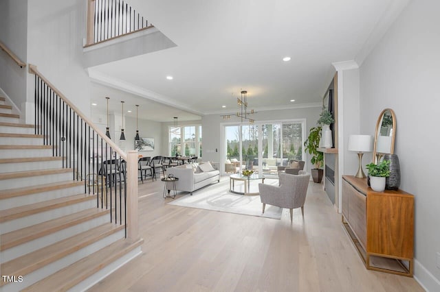 living room featuring light wood-type flooring and crown molding