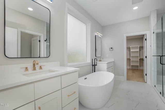 bathroom featuring vanity and independent shower and bath