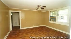 spare room with dark hardwood / wood-style floors, ceiling fan, and crown molding