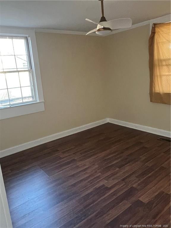 empty room with dark hardwood / wood-style floors, ceiling fan, and ornamental molding