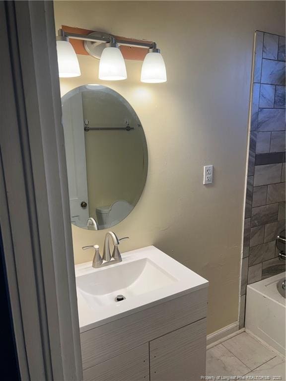 bathroom featuring tile patterned floors, vanity, and tiled shower / bath