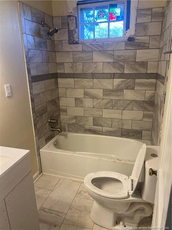 full bathroom with vanity, toilet, and tiled shower / bath