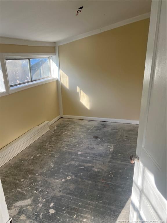 unfurnished room featuring crown molding