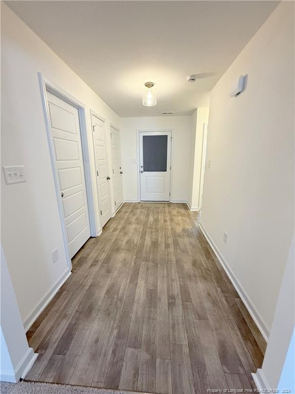 hallway with hardwood / wood-style floors