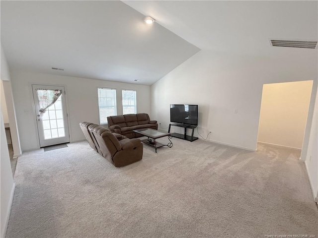 living room featuring light colored carpet and lofted ceiling