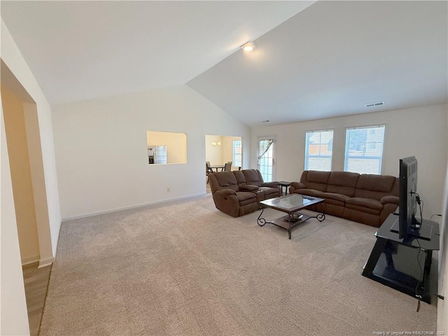 living room featuring light colored carpet and vaulted ceiling