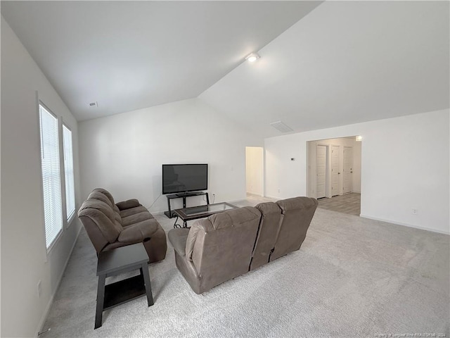 living room with light carpet and vaulted ceiling