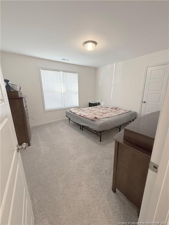 bedroom with light colored carpet